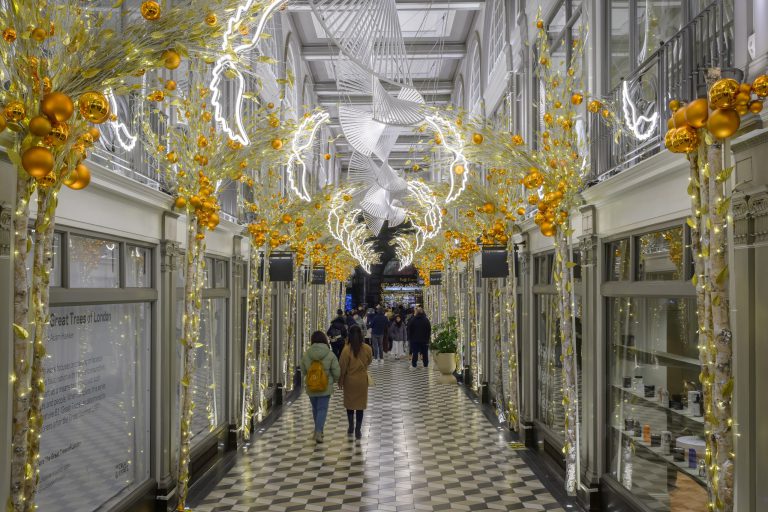 Gold foliage and white light sculptures decorating Quadrant Arcade, London