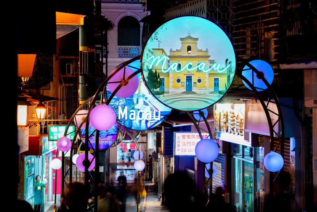 Light Up Macau: neon Macau sign and illuminated globes over a street, Macau