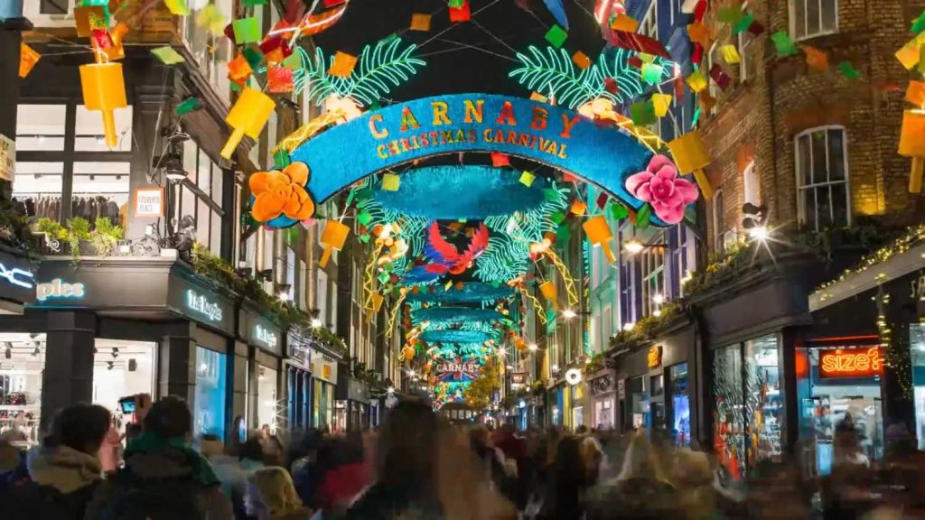 Carnaby Carnival: colourful carnival decorations and arch above Carnaby Street, London