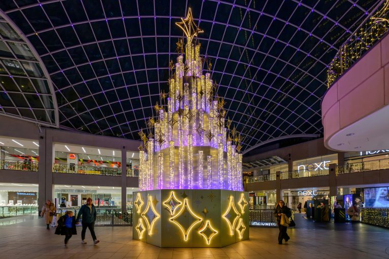 The North Star: illuminated Christmas tree with star base under the dome of Trinity Leeds