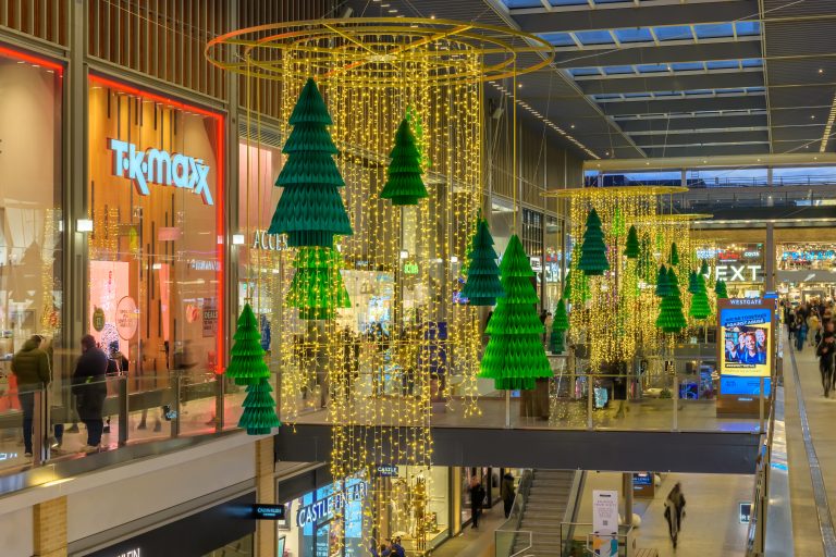 Festive Forest: green Christmas tree sculptures and golden light curtains in Westgate, Oxford