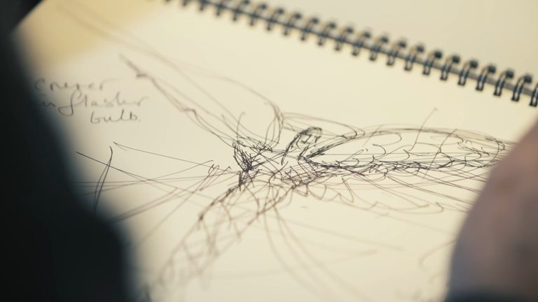 Hand-drawn design sketch in a spiral sketchbook