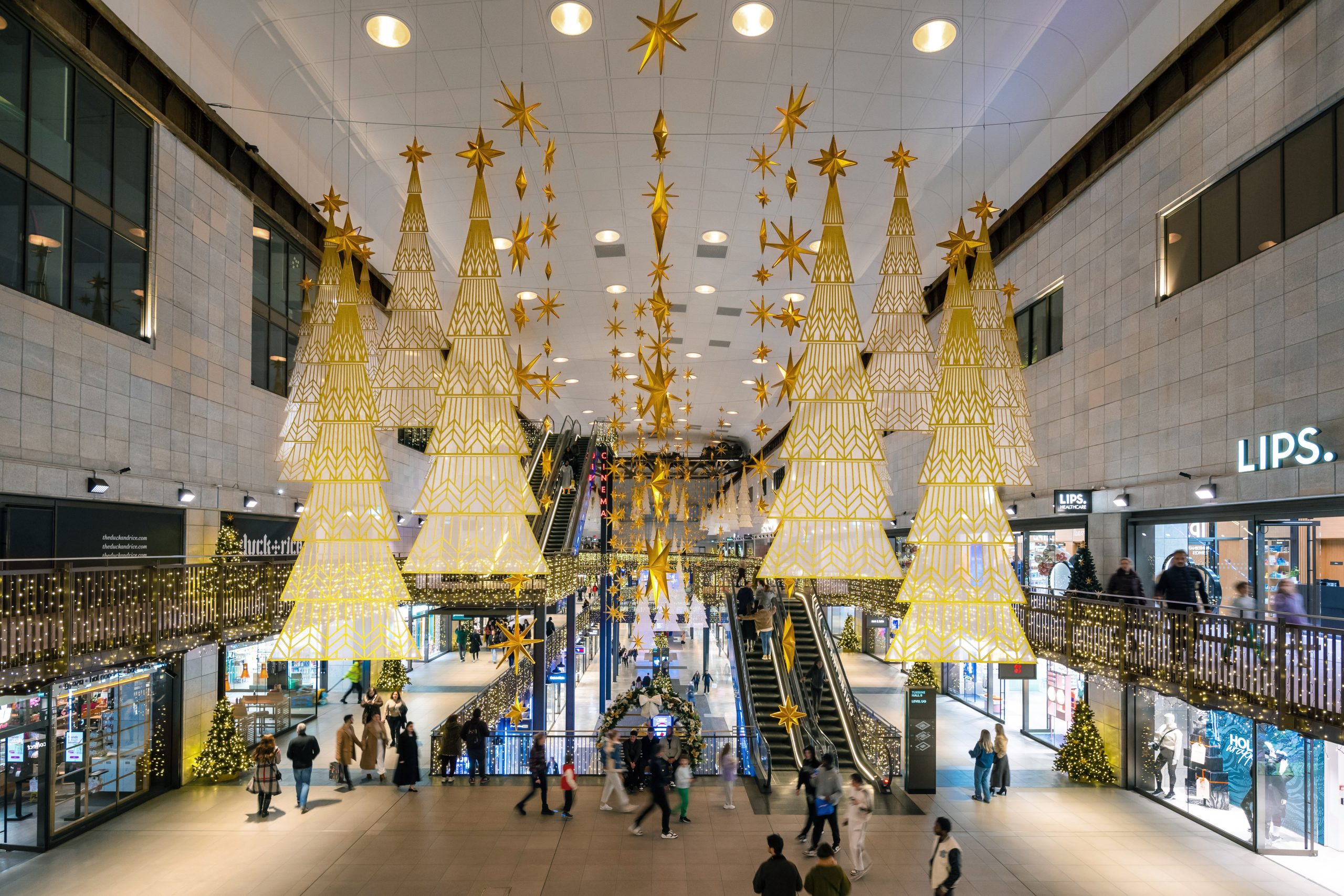 Art Deco Christmas: golden cone trees and hanging stars in Battersea Power Station, London